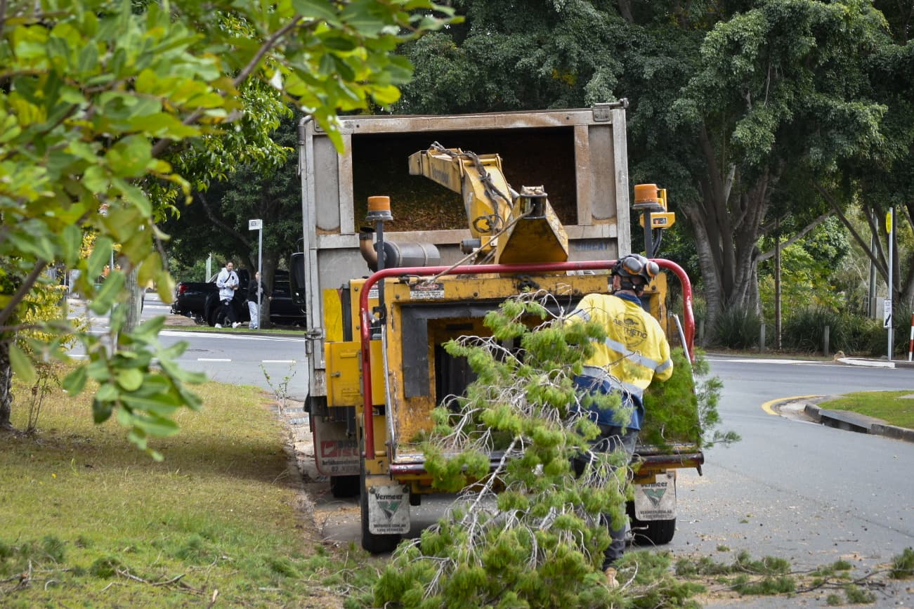 Wood chipper processing branches on site